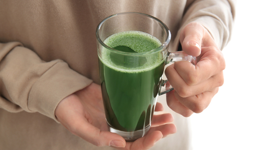 Woman holding green juice