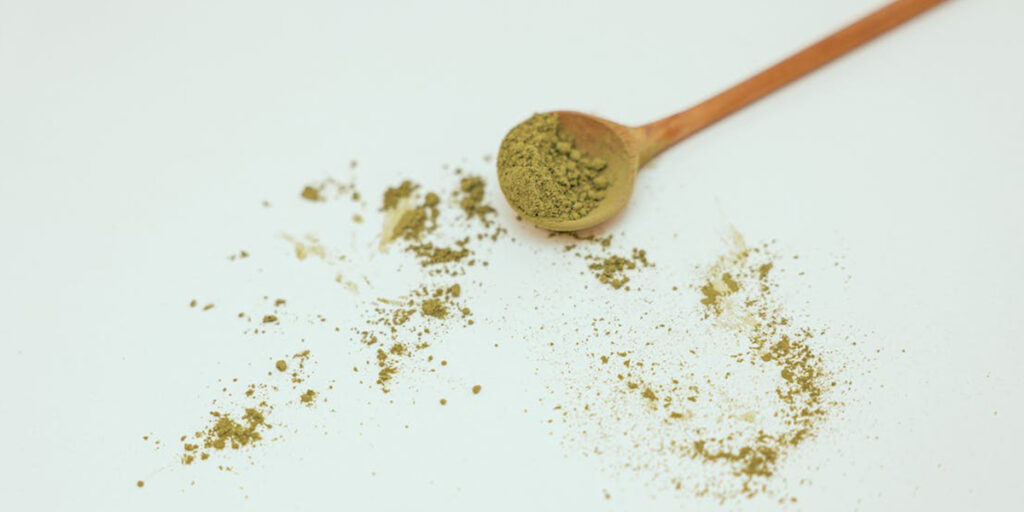 Brown Wooden Spoon with Green Powder