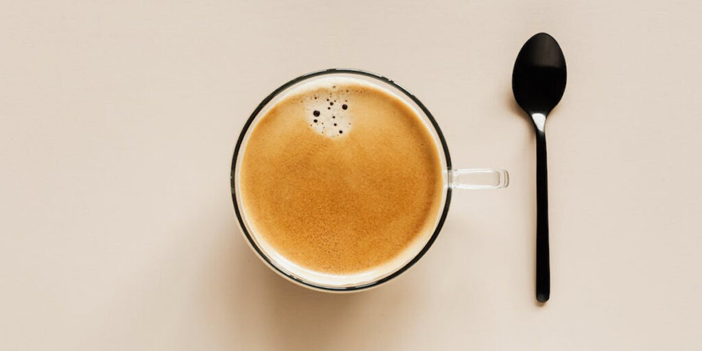 Cup of coffee and spoon of table