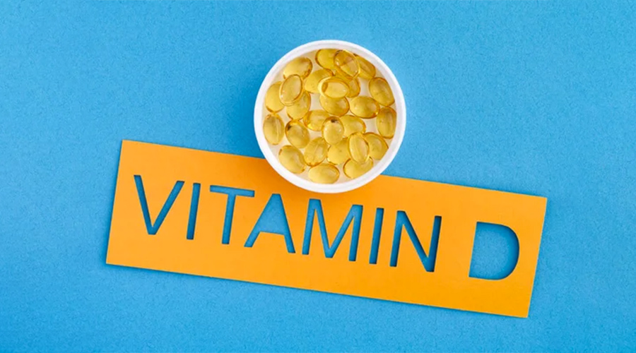 The word Vitamin D with a small cup of Vitamin D3 capsules